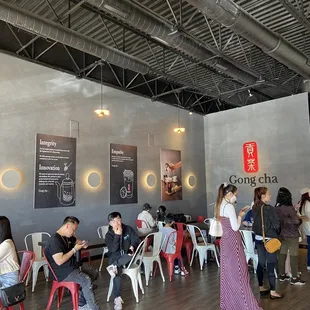 a group of people sitting at tables in a restaurant