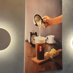a person pouring coffee into a cup