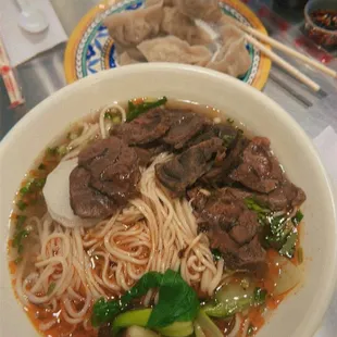 (Bottom) Spicy base, beef pulled thin noodles (top) boiled chive dumplings