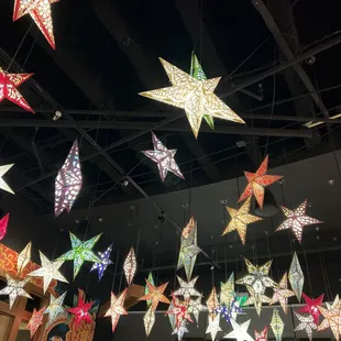 a variety of stars hanging from the ceiling