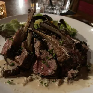 Colorado lamb lollipops and garden vegetables in a brandy-peppercorn sauce.