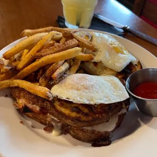 Croque Madame brunch. Honey baked ham, sharp aged white cheddar cheese &amp; sauce Mornay on sourdough bread topped with 2 over easy eggs.