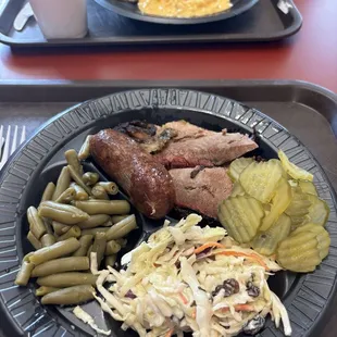 Brisket, sausage, green beans, coleslaw, and pickles.