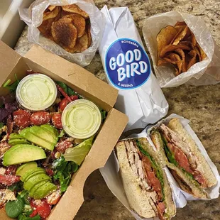 a sandwich, salad and chips