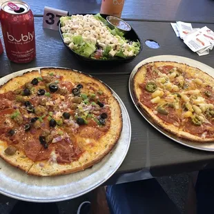 two pizzas and a salad