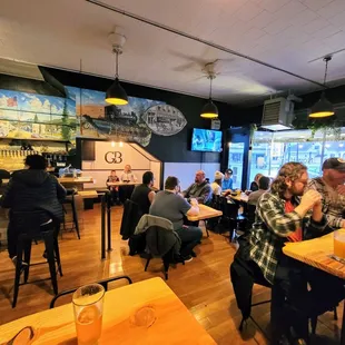 people sitting at tables in a restaurant