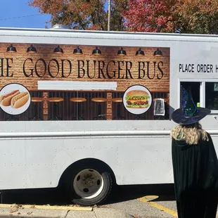 a woman standing in front of a food truck