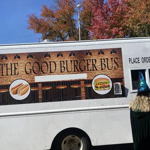 a woman standing in front of a food truck