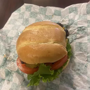 a sandwich with lettuce and tomatoes
