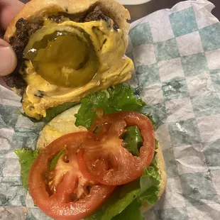 a hand holding a hamburger