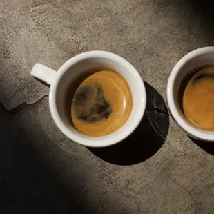 two cups of coffee on a table