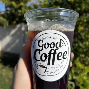 a hand holding a cup of coffee