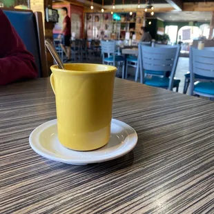a yellow cup and saucer