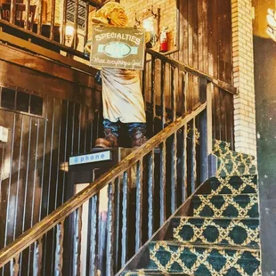 a man standing on the stairs of a restaurant