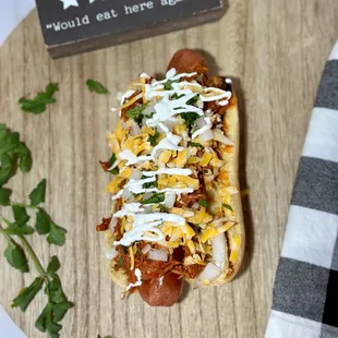 a hot dog with cheese and toppings