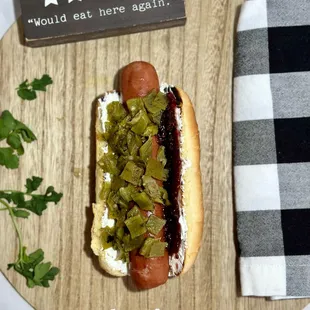 a hot dog with pickles and mustard