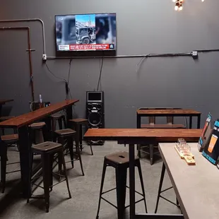 a bar with tables and a television