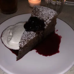 Flourless chocolate cake with cherries and cream