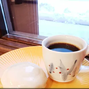 a person holding a cup of coffee