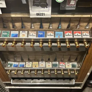 A original vintage cigarette dispenser and is dispenses!