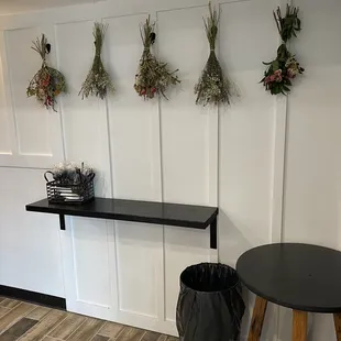 a row of dried herbs hanging on a wall