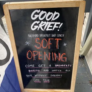 a sign for a soft opening