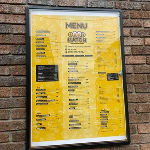 a menu on a brick wall