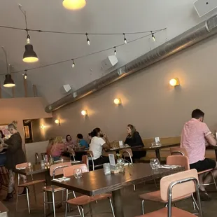 people sitting at tables in a restaurant