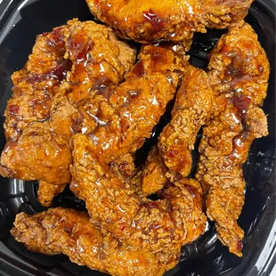 fried chicken wings in a plastic container