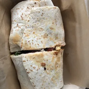 a burrito in a styrofoam container