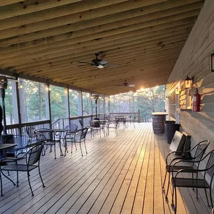 a porch with chairs and tables