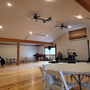 a large room with white tables and white chairs
