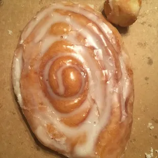 Always fresh, fast and friendly service.   (Donut hole shown next to Cinnamon Roll to show size)