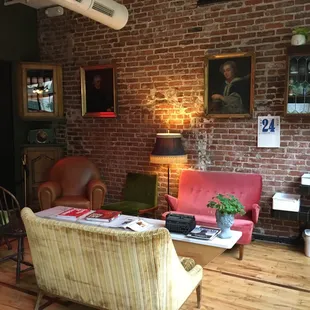a living room with a brick wall