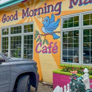a truck parked in front of a cafe