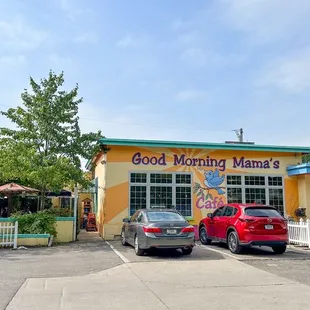 two cars parked in front of a restaurant