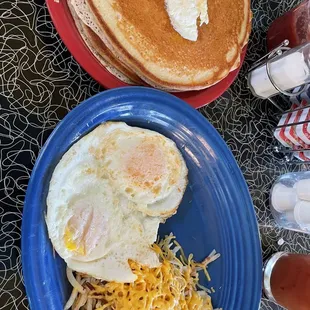 Pancake breakfast with 2 eggs, hash browns (bacon not shown)