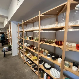 a room full of shelves with dishes on them