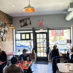 people sitting at tables in a restaurant