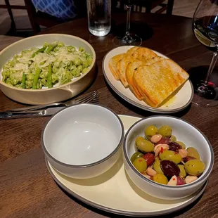 Olives, garlic bread, and pesto pasta