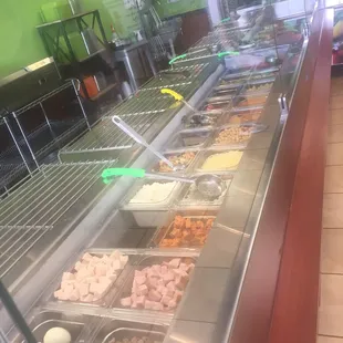 a variety of salads in a display case