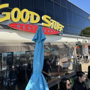 Outside seating includes tables with umbrellas or tables on a glass-enclosed area under an awning.