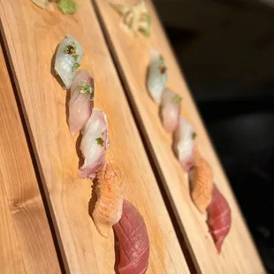 a variety of sushi on a wooden board