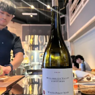 a bottle of wine sitting on a counter