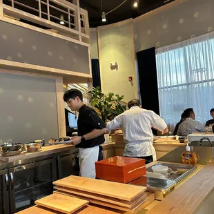 two men preparing food in a restaurant