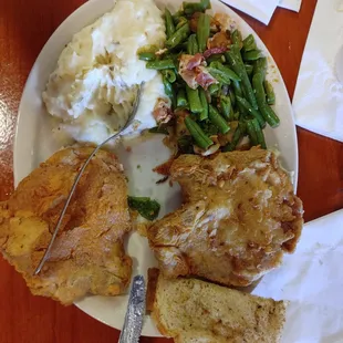 Fried pork chops, green beans with bacon and mashed potatoes