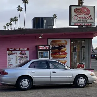 a car parked in front of a donut shop
