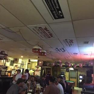 people sitting at tables in a bar