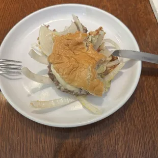 A partially eaten burger--gross! Shows how the bun collapsed.
