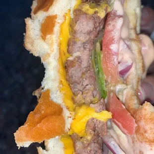 a hand holding a sandwich